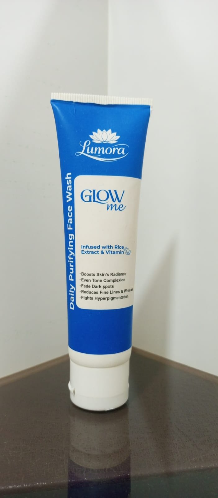 woman using Lumora Care skincare product at home